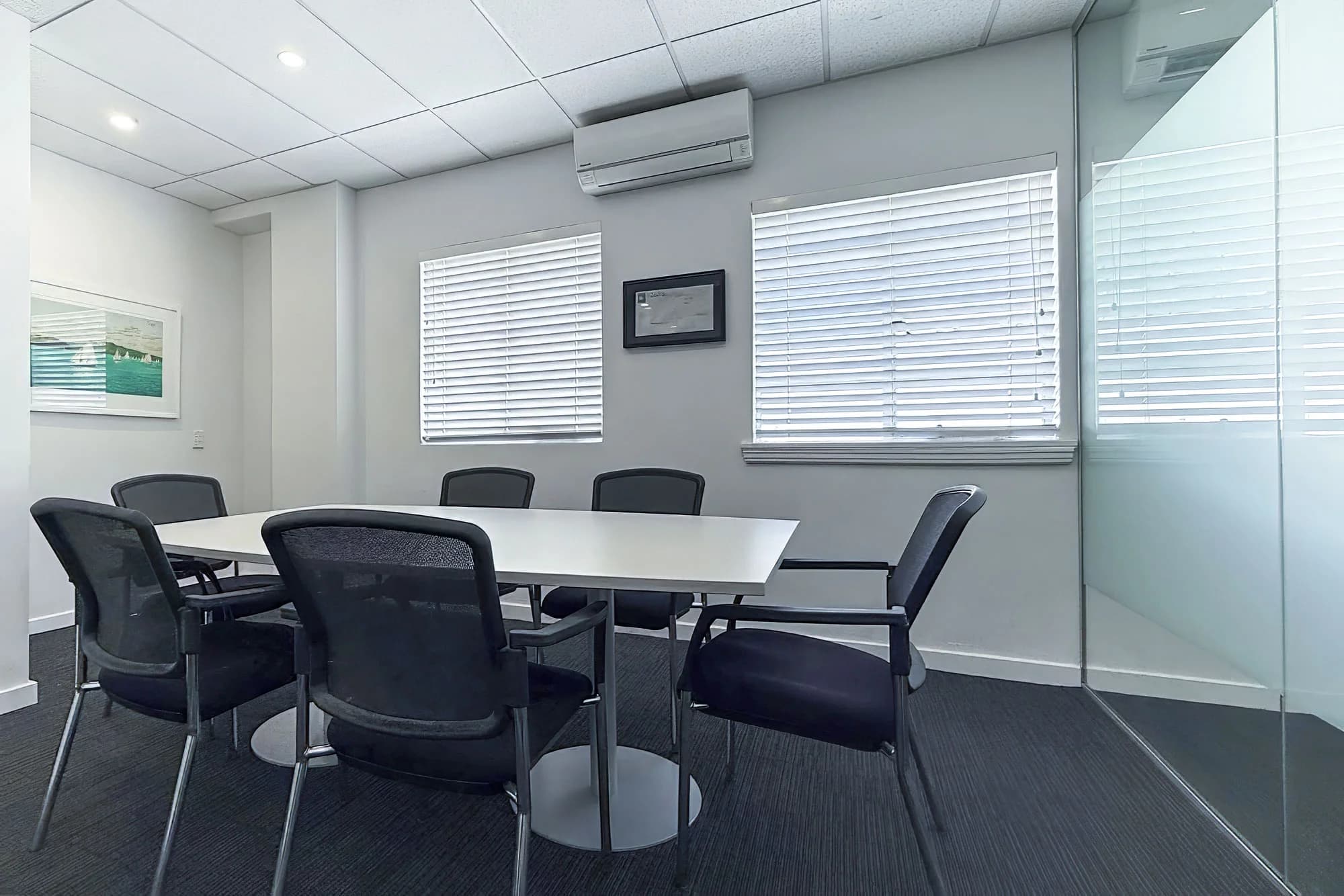 Large meeting room at The Balance Project with rectangular table seating six