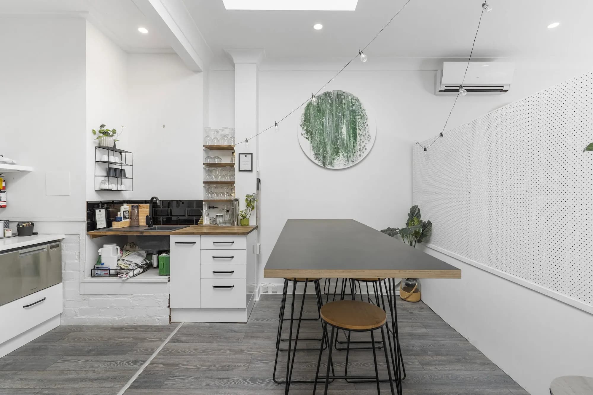 Kitchen and communal table under the skylight at The Balance Project